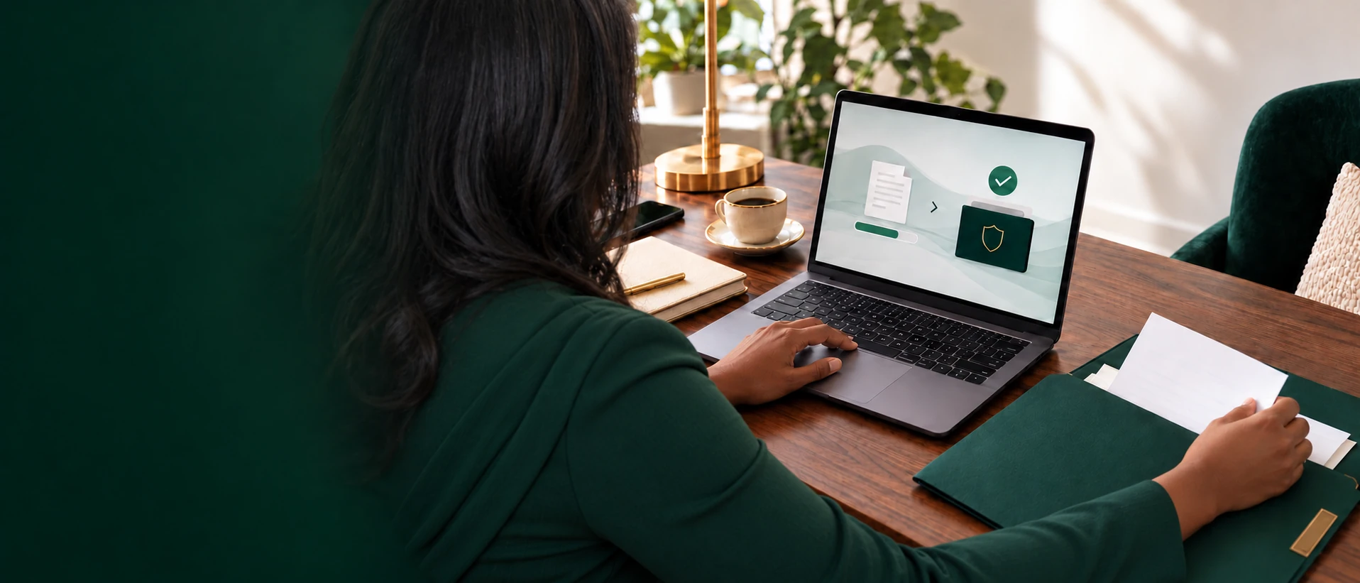 Adam Tax & Assoc. professional using a secure document portal at an organized walnut desk